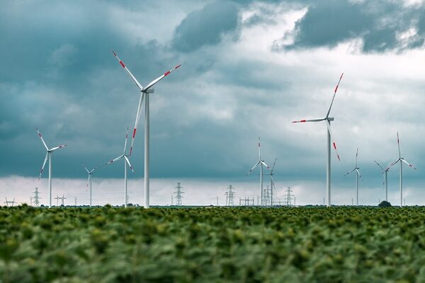 green-energy-concept-with-wind-turbines-in-field-2021-08-31-01-09-43-utc